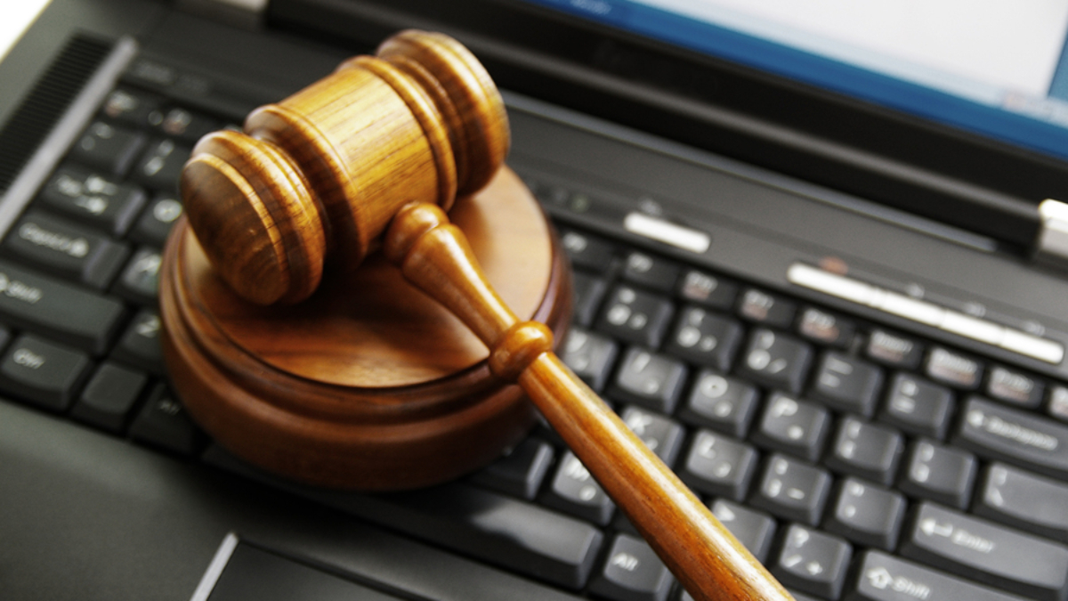 judges gavel on a laptop computer (cyber law)