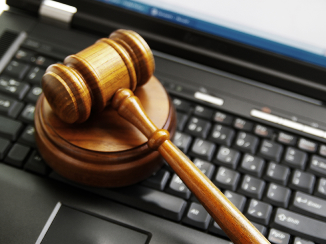 judges gavel on a laptop computer (cyber law)