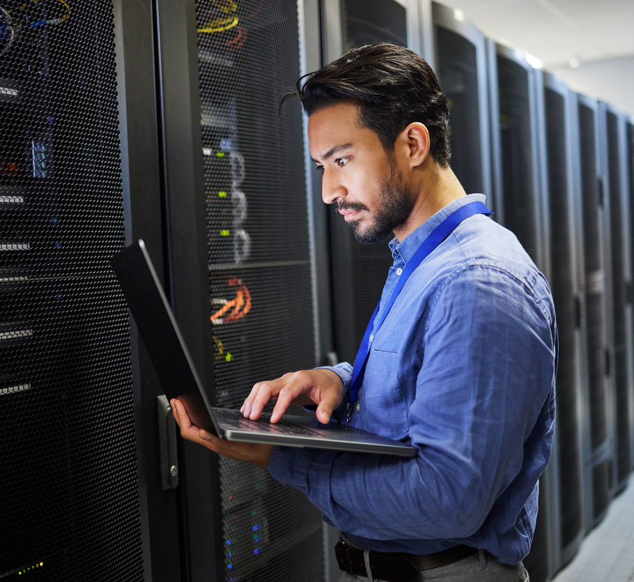 Programming, data center and a man with a laptop for maintenance, cyber security and internet check. Coding, email and an Asian programmer typing on a computer for network or server analytics